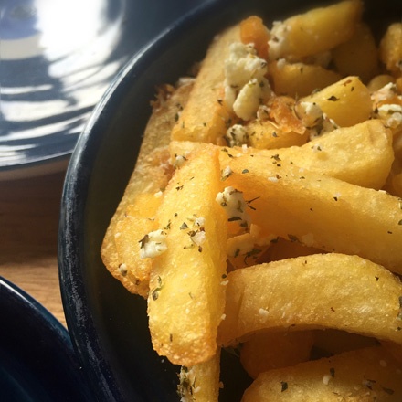 Chips cooked in garlic oil and tossed in feta and oregano