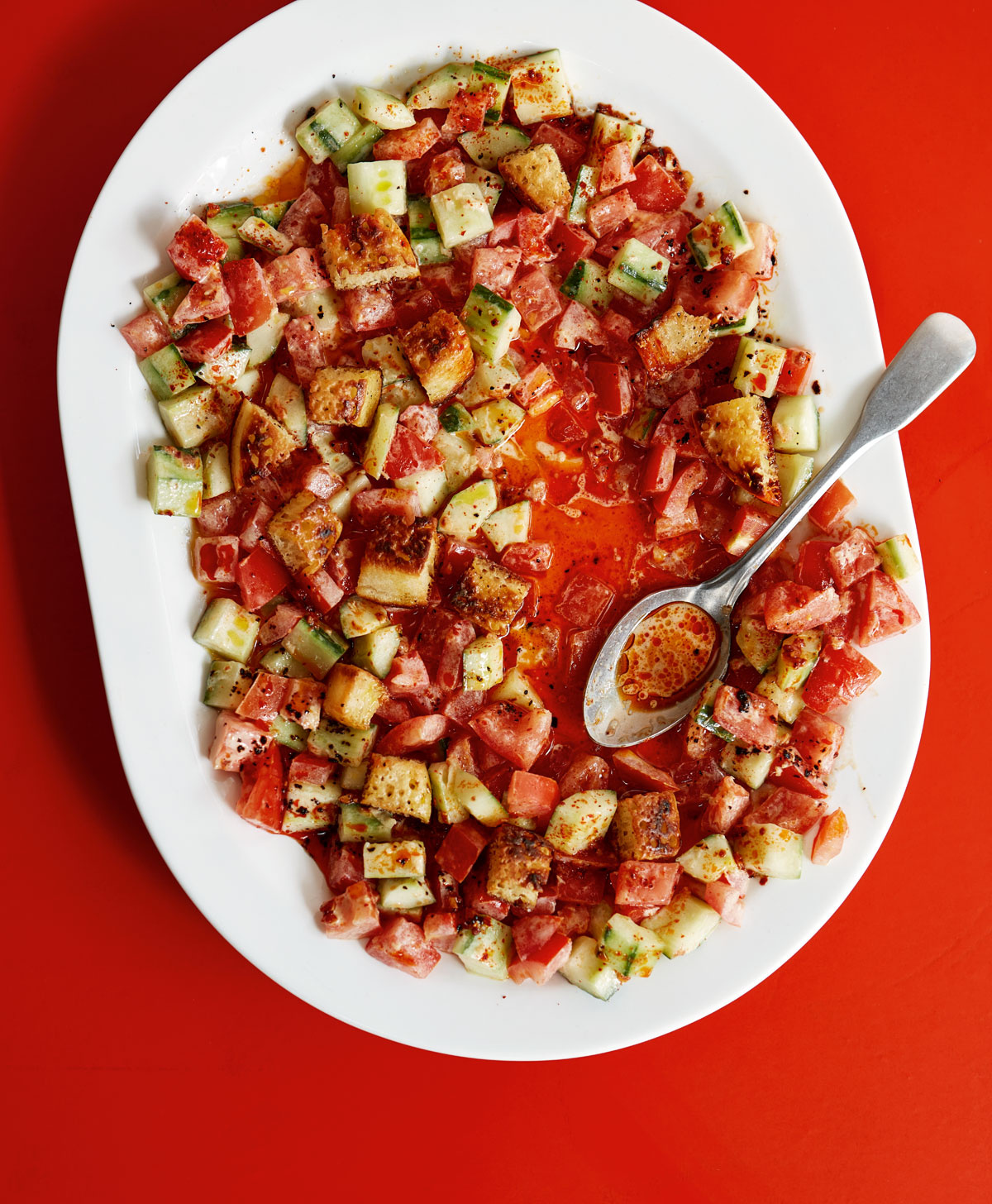 Image of Ixta Belfrage's Tomato Salad with Tahini Ginger Sauce, Chilli Oil and Crumpet Croutons